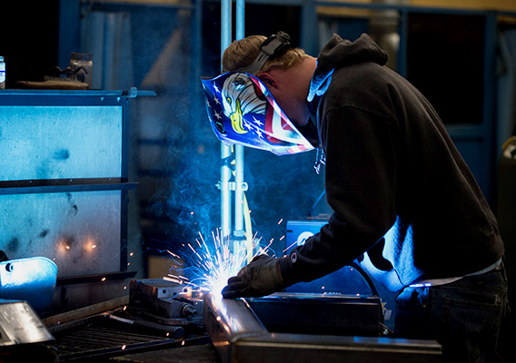 Agricultural Engineering students welds metal together during class 