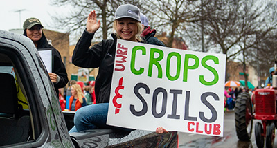 Student in the Crops & Soils club attends the Homecoming parade