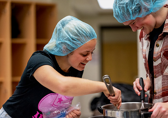 Food Science student stirs ingredients in a mixing bowl