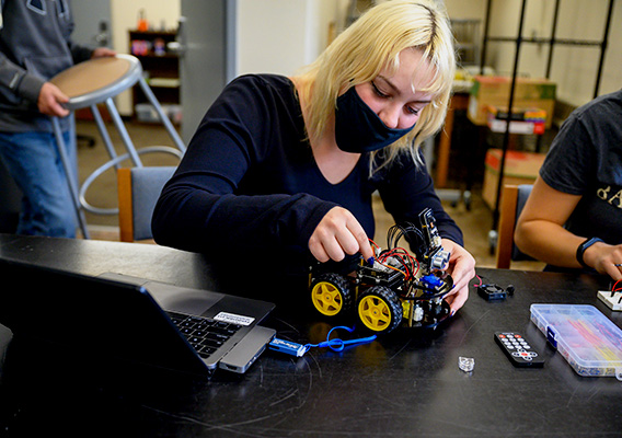 Student works on mechanical vehicle in the Makers Space