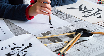 Modern Language student practicing writing Japanese letters
