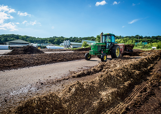 Tractor processes mulch at Mann Valley Farm