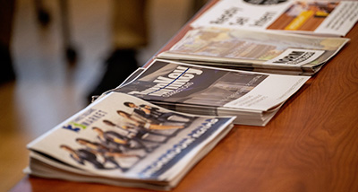 Multiple newspapers placed on a table